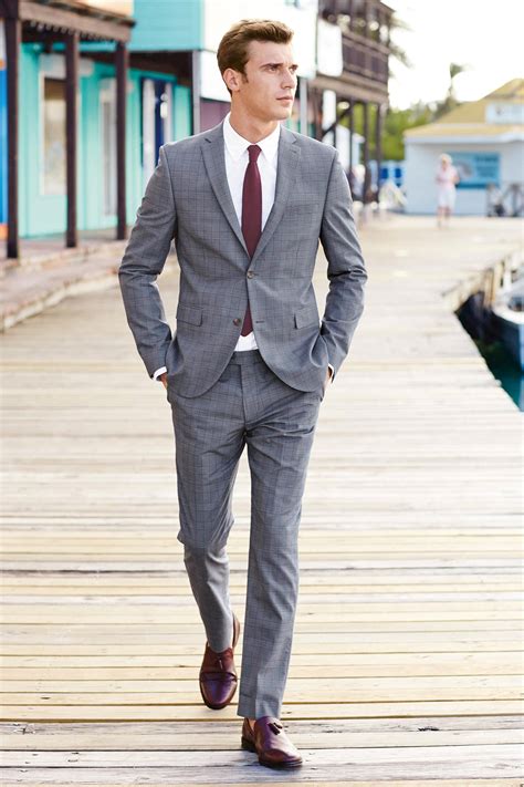 grey suit with maroon shirt.